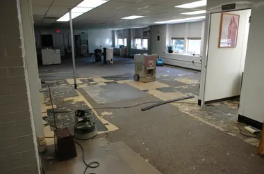 Dehumidifiers drying a large commercial room after flooding
