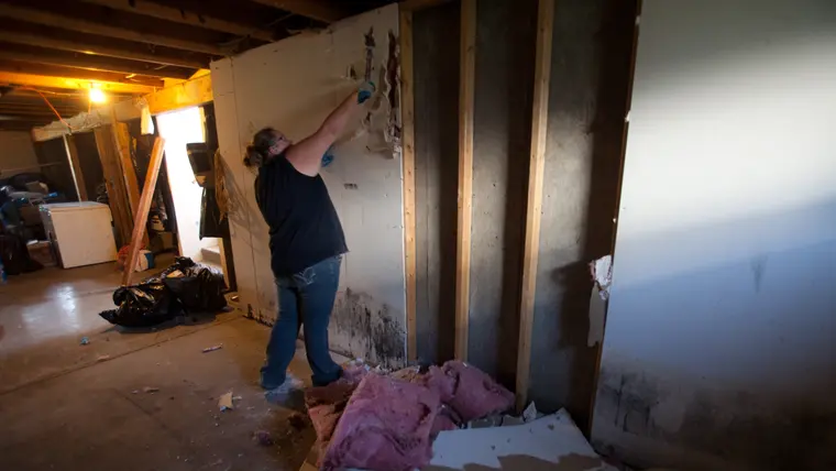 Wet wall material being torn out after water removal