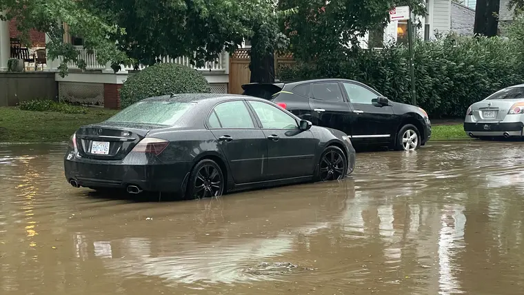 Cars sitting in flood water on a city street after a cloudburst