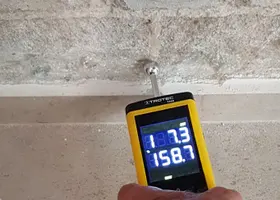 Moisture meter reading on a surface