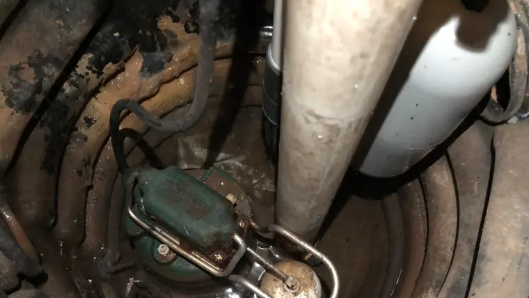 Sump pump working in a basement pit