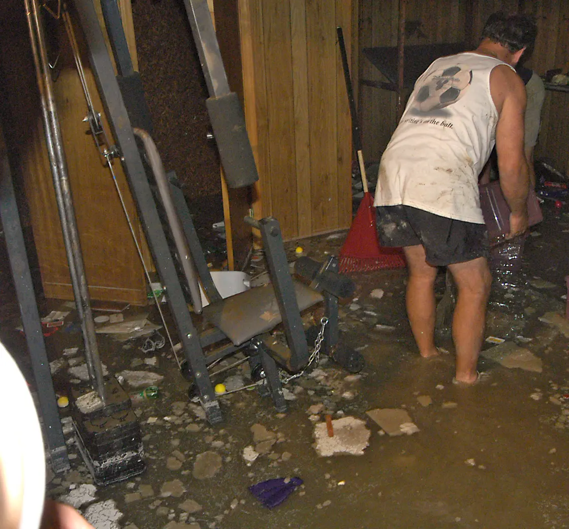 Worker clearing contaminated debris from a flooded lower level