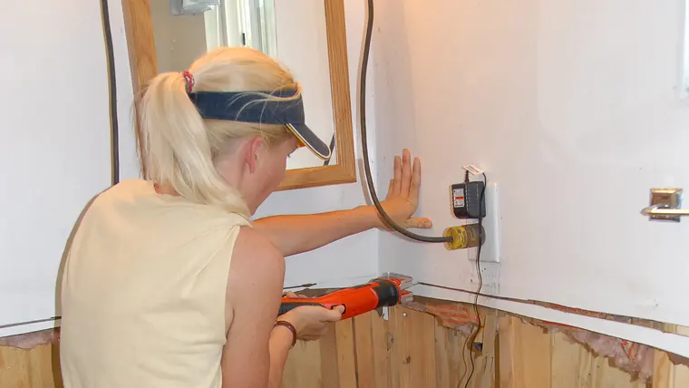 Cutting out contaminated drywall above the water line